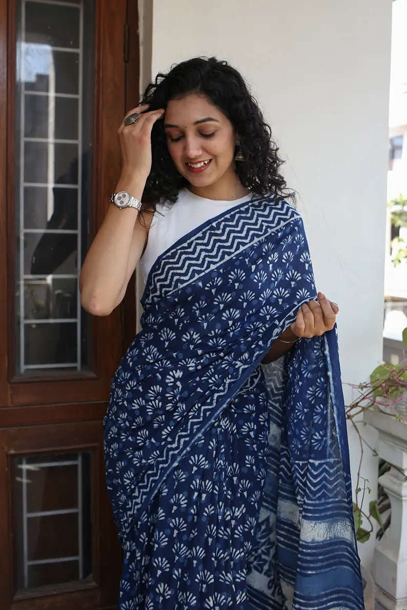 The mulmul saree is one of the most versatile and elegant pieces that you can wear. The Indigo Muse cotton saree is a great option for daily wear as it looks classy and gives you an effortless style statement. 